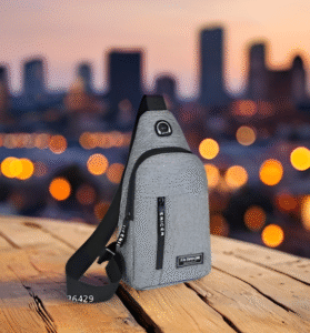 Gray unisex waterproof sling bag displayed on wooden surface